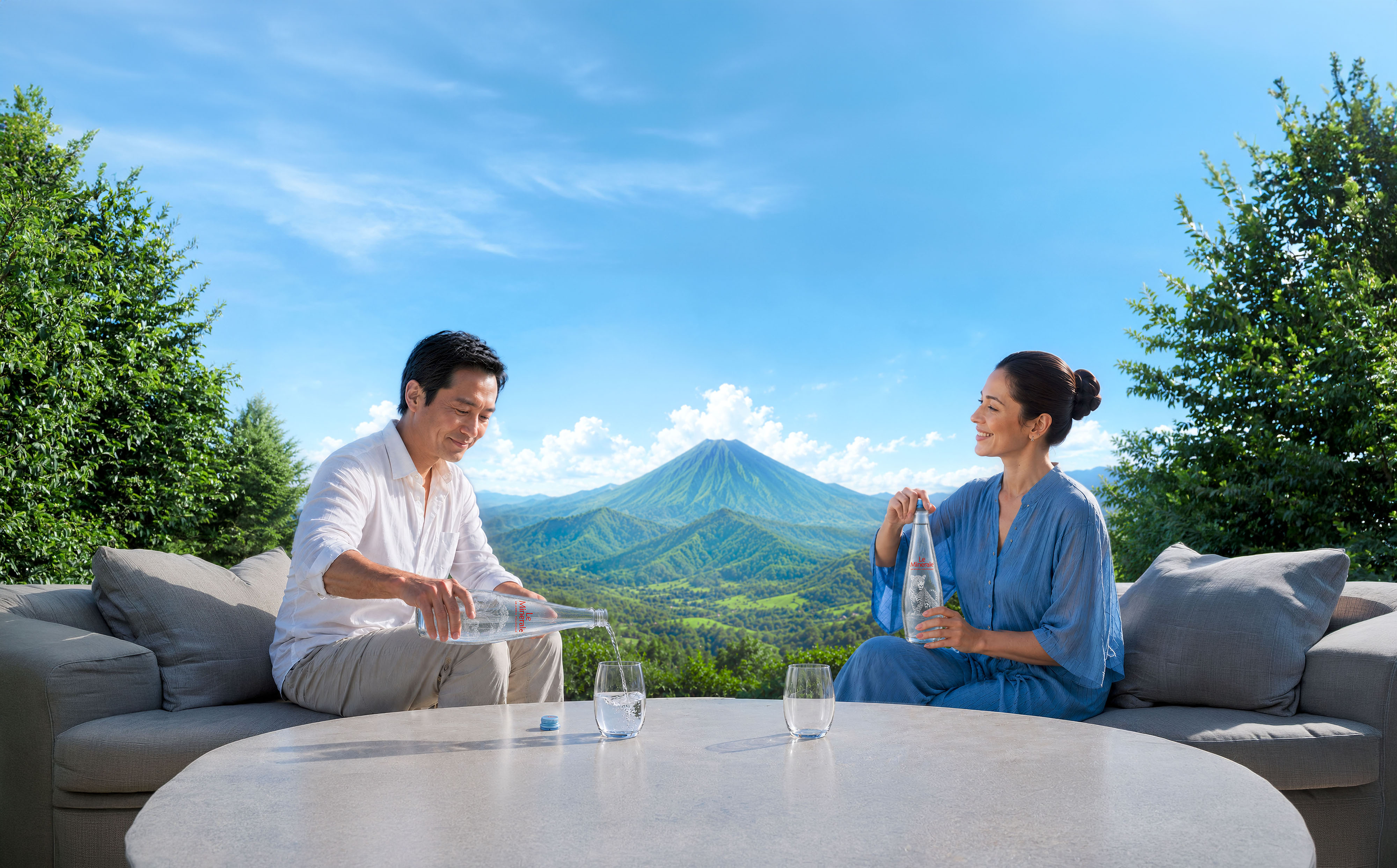 A couple enjoying Le Minerale glass bottles with a mountain view